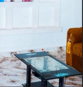 a glass coffee table in front of a couch at BP Aura Stay in Akitan