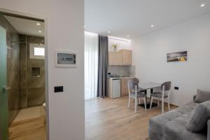 a living room with a couch and a table at Ionian View Rooms in Himare