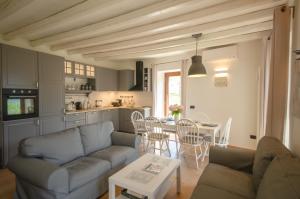 a living room with a couch and a table at cottage lavanda e rosmarino in Lavis