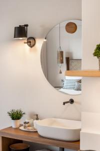 a bathroom with a sink and a mirror at Gaia-Castle vista in Monemvasia