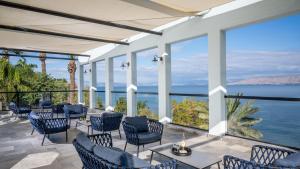 a restaurant with a view of the ocean at Jacob Ohalo Kinneret in Kinneret