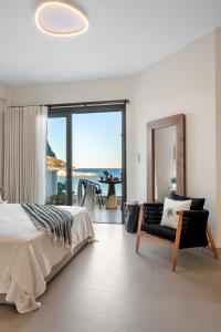 a bedroom with a bed and a view of the ocean at Gaia-Castle vista in Monemvasia