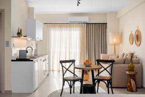 a kitchen and a living room with a table and chairs at Gaia-Castle vista in Monemvasia +29 photos