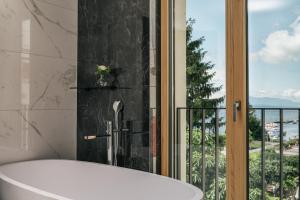 a bath tub in a bathroom with a window at Beau-Rivage Nyon in Nyon +54 photos