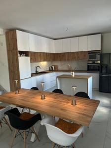 a kitchen with a wooden table and chairs at Villa Jovičić in Prijedor
