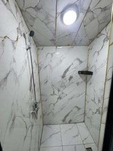 a shower with white marble walls and a ceiling at SELKINCHEK resort in Kugart +9 photos