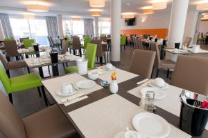 a dining room with tables and chairs in a restaurant at Hotel Westermann in Osnabrück