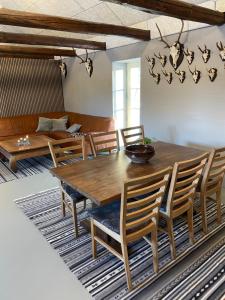 a dining room with a wooden table and chairs at Gæstehuset in Tarm