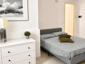 a bedroom with a bed and a white dresser at Pietra & Mare Ostuni in Villanova di Ostuni