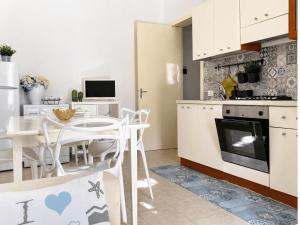 a kitchen and dining room with a table and chairs at Pietra & Mare Ostuni in Villanova di Ostuni