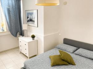 a bedroom with a bed and a night stand at Pietra & Mare Ostuni in Villanova di Ostuni