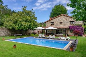 a house with a swimming pool in the yard at La Casa de Torre in Ribadesella