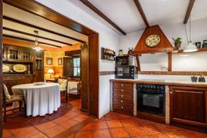a kitchen with a table and a dining room at La Casa de Torre in Ribadesella
