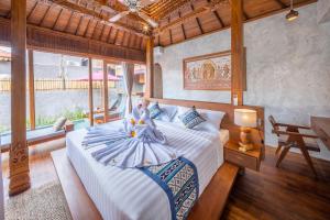 a bedroom with a large bed in a room at Bi Bi Bliss Ubud Villa in Ubud +126 photos