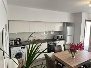 a kitchen with a wooden table and a dining room at Arsenia Cottage D - Kyperounta in Kyperounda
