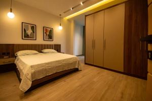 a bedroom with a bed and a large closet at Elegant Hillside Ocean Stay in Freetown