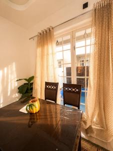 a dining room table with a bowl of fruit on it at Bougain Villa in Nashik