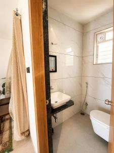 a bathroom with a sink and a toilet at Bougain Villa in Nashik