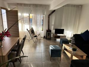 a living room with a couch and a table at Arsenia Cottage D - Kyperounta in Kyperounda