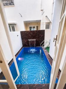 a swimming pool in the middle of a building at Bougain Villa in Nashik