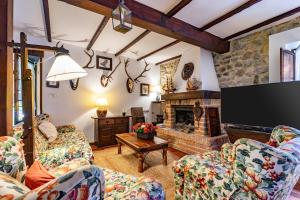 a living room with two chairs and a fireplace at La Casa de Torre in Ribadesella