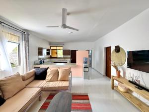 a living room with a couch and a kitchen at KK Homes in Diani Beach