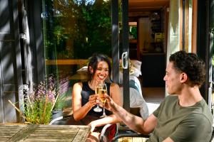 a man and woman sitting at a table drinking wine at Bird Box in Carlisle