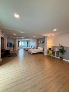 a large living room with a couch and a table at The See Stay Hatyai in Hat Yai