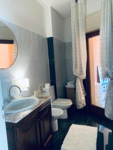 a bathroom with a sink and a toilet and a mirror at Suite bijoux On Lake Maggiore in Verbania +105 photos