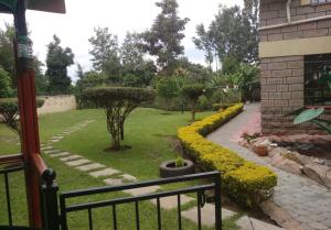 a view of a garden with trees and bushes at Mutabari's Home in Kitengela 