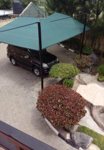 a blue umbrella sitting on top of a car at Mutabari's Home in Kitengela  +2 photos