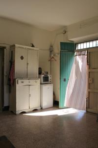 cocina antigua con nevera y ventana en Casa Cucuzzolo, en Isca sullo Ionio