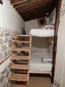 a room with two bunk beds and a ladder at Casa Cucuzzolo in Isca sullo Ionio