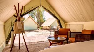 a tent with chairs and a table in it at Jacob Mitzpe Ramon in Mitzpe Ramon