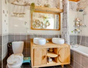 a bathroom with a sink and a toilet and a mirror at Villa L'Epicléa, Chorges, entre lac et montagnes in Chorges +51 photos