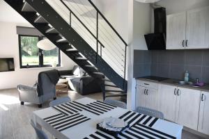 a kitchen and living room with a spiral staircase at Lubiatówki in Lubiatowo +41 photos