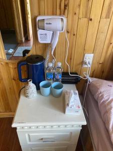 a table with a coffee maker and cups on it at Dốc Mơ Homestay in Bản Bé