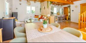 a living room with a table and chairs at Villa L'Epicléa, Chorges, entre lac et montagnes in Chorges