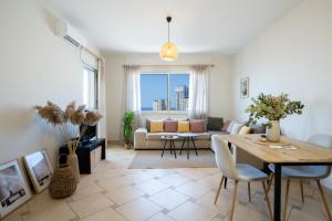 a living room with a table and a couch at Fole Maison in Durrës