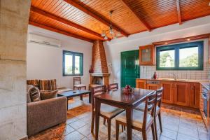 a kitchen and living room with a table and a couch at Metochi Villas in Spílion