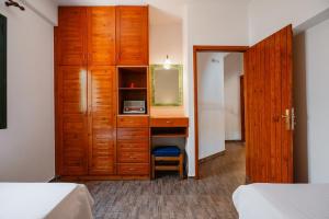 a bedroom with a desk and a dresser with a mirror at Metochi Villas in Spílion