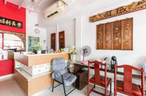 a kitchen with a table and chairs in a room at 1137 Hostel in Bangkok