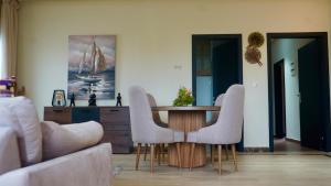 a living room with a table and two chairs at Villa La Gospa in Libreville +51 photos