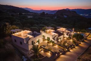 an aerial view of a house with lights at Metochi Villas in Spílion