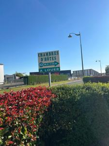 a sign for a hotel on the side of a road at Chambres Saint-Jamaises in Saint-James