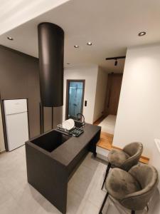 a office with a black desk and two chairs at Orestiada Centro apartment in Orestiada