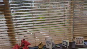 a window with wooden blinds in a room at Rashas double room in London