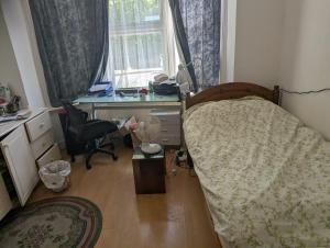 a bedroom with a bed and a desk and a chair at Rashas double room in London
