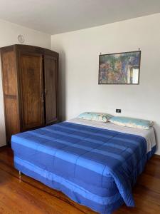 a bed in a room with a blue mattress at La Cà di Carol Apartment in Andorno Micca
