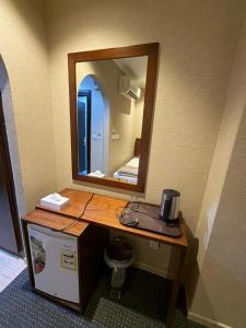 a bathroom with a vanity with a mirror at Al Maqam Alsharqy Shuttle Srevice to Haram in Mecca